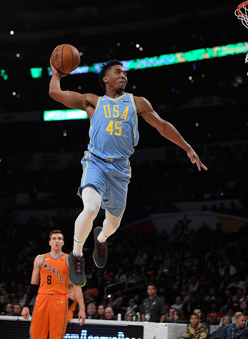 U.S. Team's Donovan Mitchell, of the Utah Jazz, goes up for a dunk as Bogdan Bogdanovic, of the Sacramento Kings, watches during the NBA All-Star Rising Stars basketball game, Friday, Feb. 16, 2018, in Los Angeles. The World Team won 155-124. (AP Photo/Mark J. Terrill)