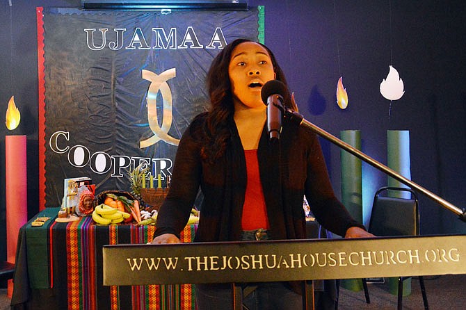 SaBria Hendricks performs Friday during a Kwanzaa celebration, "Cooperative Economics," at The Joshua House Church.