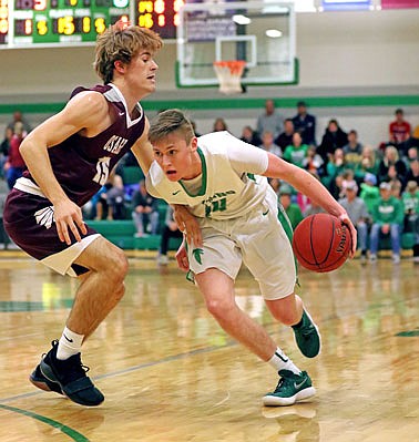 Tim Fick of Blair Oaks tries to drive past Drake Gaines of School of the Osage during Friday night's game in Wardsville.