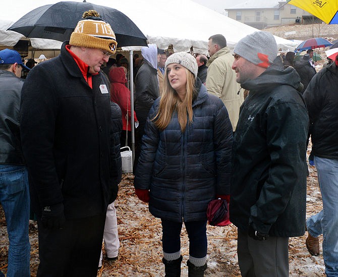 Ben Meldrum, right, Capital City High School's principal, chats with Gary Verslues and Libby Wilson during groundbreaking ceremonies Saturday for the future school. The new school will be located at 2653 Creek Trail Drive.

