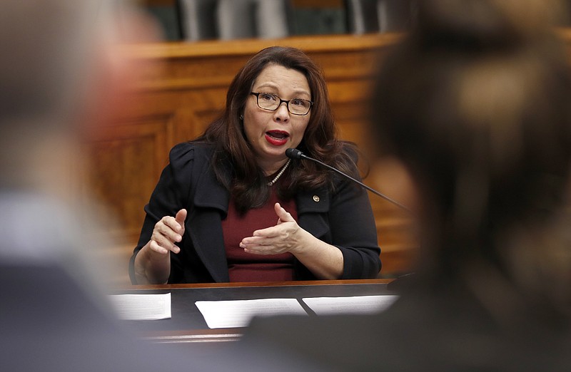 In this Feb. 14, 2018, photo, Sen. Tammy Duckworth, D-Ill., speaks to Goldman Sachs 10,000 Small Businesses Summit, on Capitol Hill, in Washington. Duckworth doesn't blend in, and that's the way she likes it. The decorated Iraqi War veteran who lost both legs when her helicopter was shot down is an Asian-American woman in the mostly-white, mostly-male and very fusty Senate. And now, with a baby due in April, the Illinois Democrat will be the first senator to give birth while in office. (AP Photo/Alex Brandon)