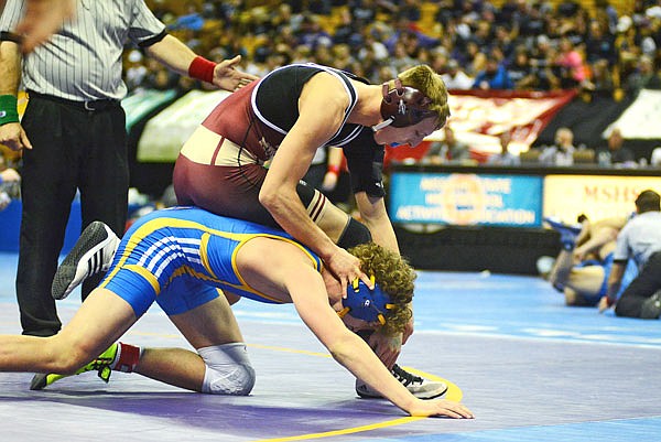 Eldon's Trenton Dillon forces Bolivar's Hayden Burks to the mat during a state championship match at the Class 2 state championships at Mizzou Arena. Dillon became the school's first modern state wrestling champion with a 2-1 victory in the 160-pound title match.
