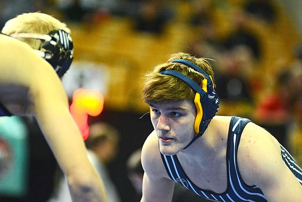 Helias' Nick Schnieders stares down Kearney's Ethan Locke during their third-place match Saturday in the Class 3 state championships at Mizzou Arena.