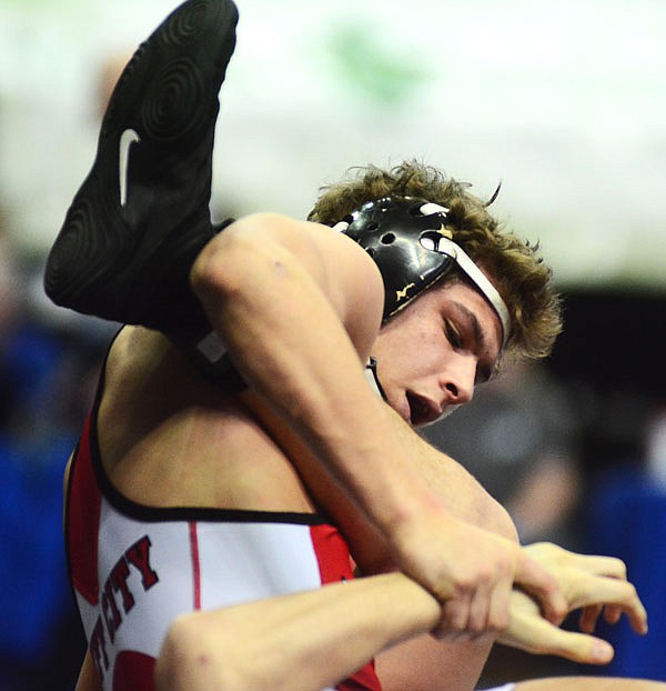 Jefferson City's Peter Kuster tangles with Fort Zumwalt West's Austin Landow during a fifth-place match Saturday in the Class 4 state championships at Mizzou Arena.