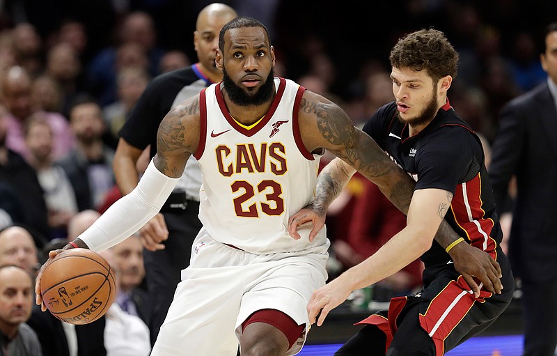 In this Wednesday, Jan. 31, 2018 file photo, Cleveland Cavaliers' LeBron James, left, drives past Miami Heat's Tyler Johnson in the second half of an NBA basketball game in Cleveland.  (AP Photo/Tony Dejak, File)