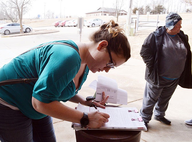Virginia Fletcher signs a pro medical marijuana initiative outside the Department of Motor Vehicles on  Wednesday.