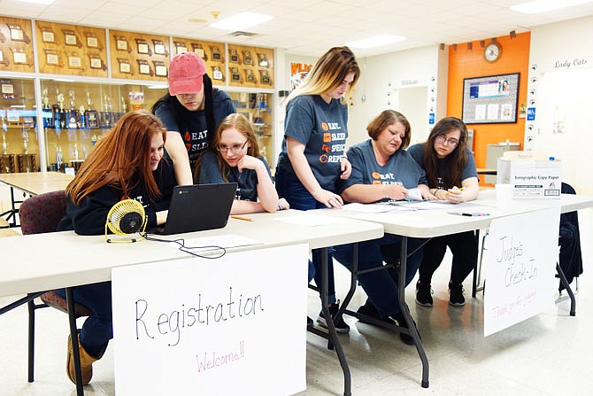 Members of the New Bloomfield High School speech team, along with coach Beth Heldrich, second from right, prepare to welcome contestants to Friday's speech tournament. Heldrich said this is the third year New Bloomfield has hosted a tournament.