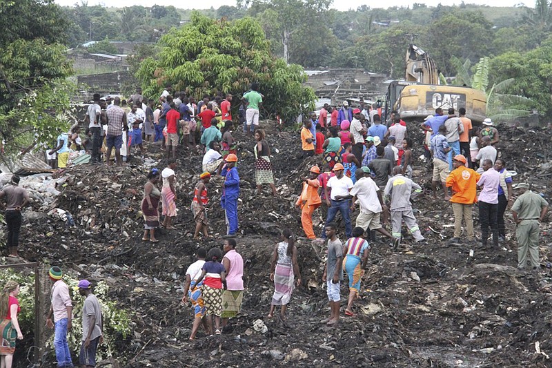 Rescuers search for survivors at the collapse of a garbage mound in Maputo, Mozambique, Monday, Feb. 19, 2018. Mozambican media say at least 17 people died when heavy rains triggered the partial collapse of the mound garbage. (AP Photo/Ferhat Momade)
