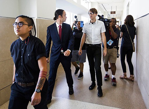 FILE - In a Thursday, Aug. 17, 2017 file photo, from left, Ngoc Loan Tran, 24, Peter Gull Gilbert, 36, and Dante Strobino, 35, leave a courtroom in the Durham County Courthouse after their first court appearance after being arrested for the toppling of the Durham County confederate statue during a protest, in Durham, NC. A North Carolina judge trying protesters accused of toppling a Confederate statue  on Monday, Feb. 19, 2018, dismissed the criminal case against Strobino. (Casey Toth/The Herald-Sun via AP, File)