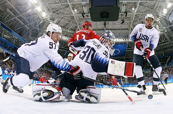 U.S. teammates Matt Gilroy (left), goalie Ryan Zapolski andJordan Greenway reach for the puck during the first period of Saturday's 4-0 loss to the team from Russia in Gangneung, South Korea