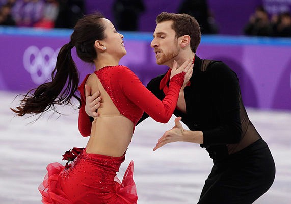 In this Sunday Feb. 11, file photo, Yura Min and Alexander Gamelin of South Korea perform during the ice dance short dance team event in the Gangneung Ice Arena at the Winter Olympics in Gangneung, South Korea. The pair are among three dozen skaters in the Pyeongchang Games are performing for nations in which they were not born.