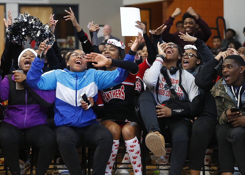 In this Feb. 16, 2018, photo, University Prep Academy High School students react in Detroit to an announcement that all 600 students will see the film "Black Panther." As the film debuts in theaters across the U.S., educators, philanthropist, celebrities, and business owners are pulling together their resources to bring children of color to see the film which features a black superhero in a fictional, un-colonized African nation. (AP Photo/Paul Sancya)