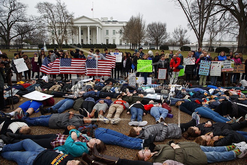 Demonstrators participate in a "lie-in" during a protest in favor of gun control reform in front of the White House, Monday, Feb. 19, 2018, in Washington, D.C.