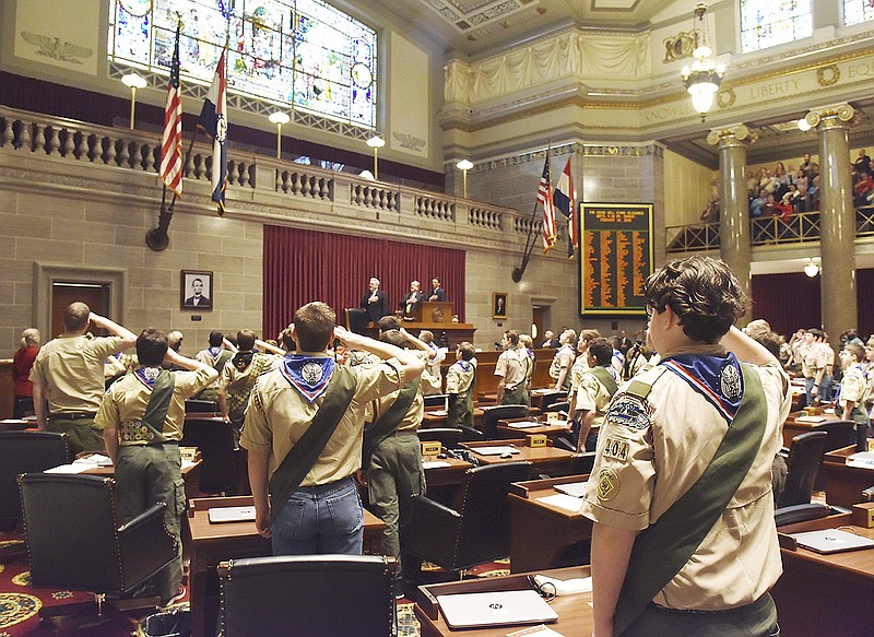 With fingers held against their foreheads, hundreds of Eagle Scouts stand Monday for the Pledge of Allegiance during an opening ceremony. The day saw numerous Missouri Eagle Scouts receive recognition in the form of hearing their name called in the Missouri House of Representatives to come forward to receive a certificate and pocket knife, along with handshakes from the presenters.