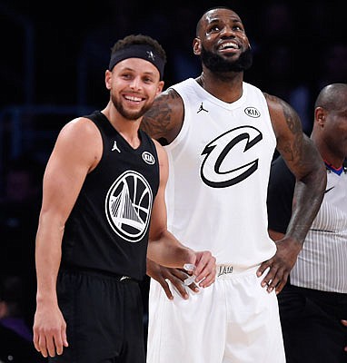 Stephen Curry of the Warriors and LeBron James of the Cavaliers stand together during Sunday night's NBA All-Star Game in Los Angeles.