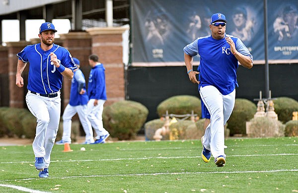 Royals catchers Drew Butera and Salvador Perez run sprints during a spring training workout Monday in Surprise, Ariz.