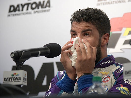 An emotional Darrell Wallace Jr. wipes his face as he speaks to the media after finishing second in Sunday's Daytona 500.