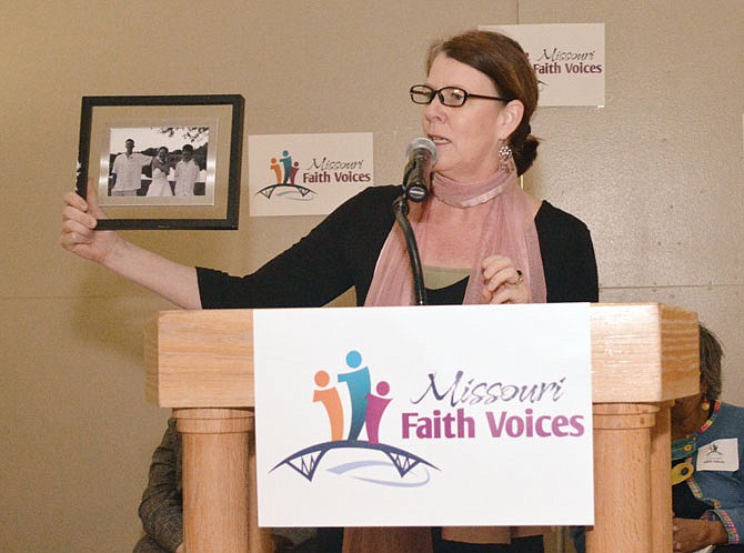 Tracy McClard shows a photograph of her children Tuesday during the Missouri Faith Voices rally in the Rotunda.