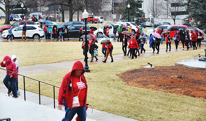 Participants of the Moms Demand Action for Gun Sense in America rally march Tuesday from Capitol Plaza Hotel to the Capitol. 