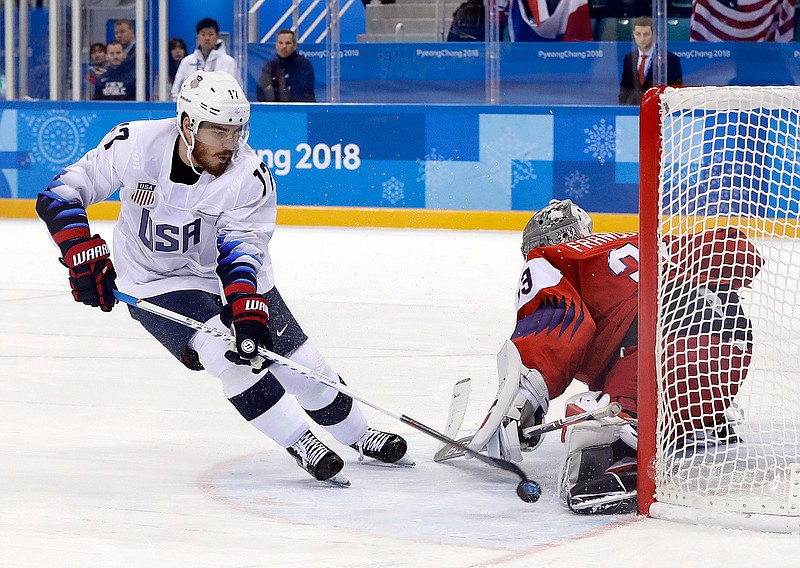 Goalie Pavel Francouz (33), of the Czech Republic, blocks a shot by Chris Bourque (17), of the United States, during the penalty shootout in the quarterfinal round of the men's hockey game Wednesday at the 2018 Winter Olympics in Gangneung, South Korea.