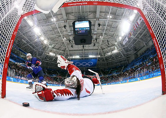 Jocelyne Lamoureux-Davidson of the United States scores the game-winning goal past Canada goalie Shannon Szabados in the penalty shootout of the women's gold medal game Thursday at the Winter Olympics in Gangneung, South Korea.