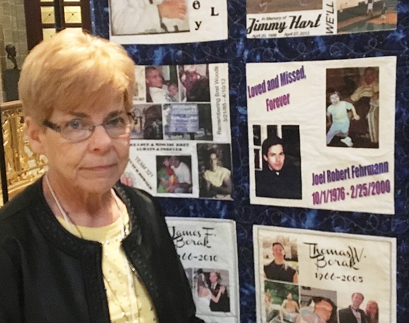 Linda Fehrmann, of St. Charles, stands next to a Lifekeeper Memory Quilt, which includes photos of her son, Joel, who committed suicide nearly 18 years ago on Feb. 25, 2000. She was at Foundation for Suicide Prevention Capitol Day on Wednesday, Feb. 21, 2018.