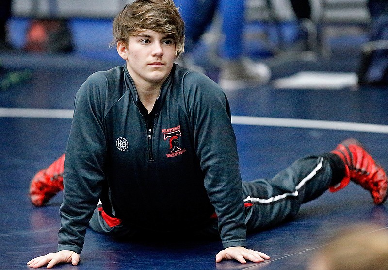 In this Saturday, Feb. 17, 2018 photo, Trinity High School wrestler Mack Beggs warms up before her match at the 6A Region II wrestling meet held at Allen High School in Allen, Texas . Beggs, a senior from Euless Trinity High School near Dallas is transgender and in the process of transitioning from female to male. (Stewart F. House/The Dallas Morning News via AP)