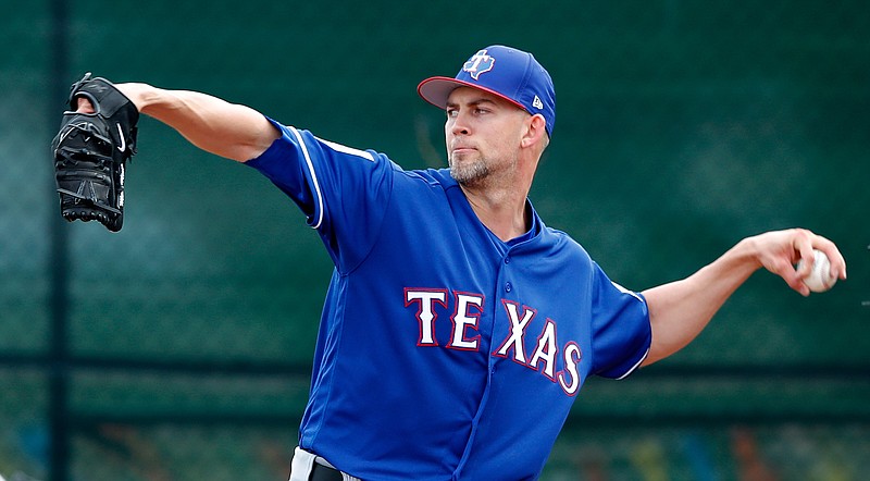 In this Feb. 15, 2018, file photo, Texas Rangers pitcher Mike Minor throws during a baseball spring training workout,in Surprise, Ariz. Minor thought he might never pitch again while missing two full seasons with shoulder issues. The former first-round draft pick now gets a chance to start again after being a full-time reliever in his return last year. (AP Photo/Charlie Neibergall, File)