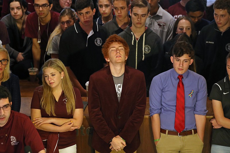 Jaclyn Corin, Ryan Deitsch and Alfonso Calderon, along with their classmates from Marjory Stoneman Douglas High, listen as fellow student Lorenzo Prado speaks at a press conference recalling the day of the shooting.  One hundred students from the Parkland high school met with legislators at the state Capitol to talk about gun control on Wednesday, Feb. 21, 2018. (Susan Stocker/Sun Sentinel/TNS)