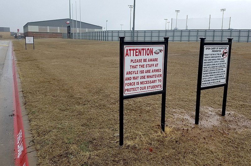 Signs alert those approaching Argyle High School in Argyle, Texas, that staff are armed. (Molly Hennessy-Fiske/Los Angeles Times/TNS)