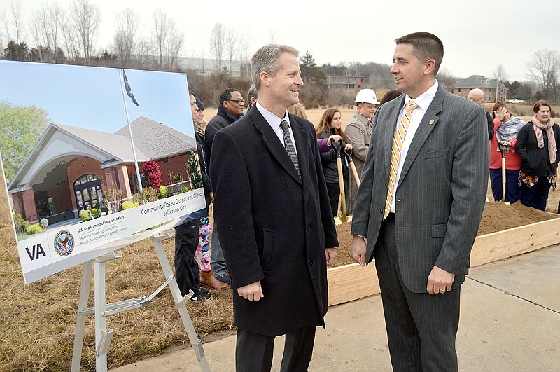 David Isaacks, Medical Center Director at the Harry S Truman Memorial Veterans' Hospital, right, and Associate Director Rob Ritter converse Friday during a groundbreaking ceremony for the new VA clinic.