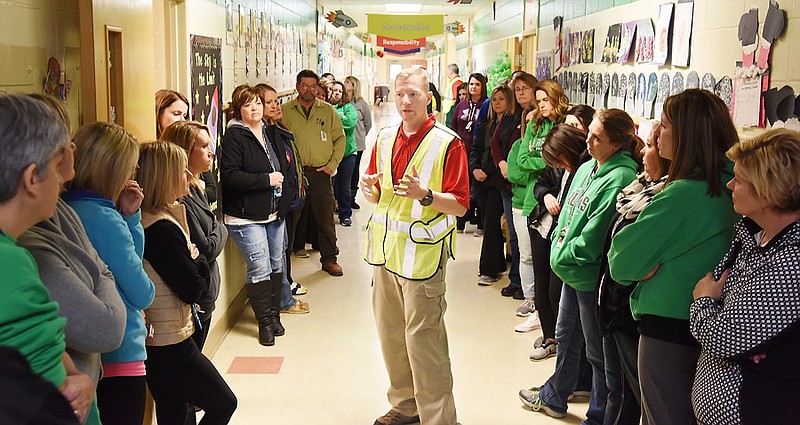 Bret Brooks of Gray Ram Tactical LLC (in safety vest) goes over several points after an intruder training presentation to teachers in January at each of the schools in the Blair Oaks School District.