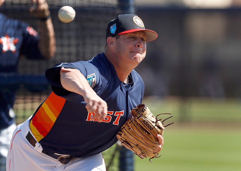 In this Feb. 19, 2018, file photo, Houston Astros pitcher Brad Peacock throws live batting practice during spring training baseball practice in West Palm Beach, Fla. Last spring Brad Peacock entered Astros camp worried that he wouldn't make the team. After the best season of his career, the right-hander's spot with the Astros is secure this season, but he's maintained the same mindset he had when his career was on the line. "I still want to keep that edge on me," he said.(AP Photo/Jeff Roberson)
