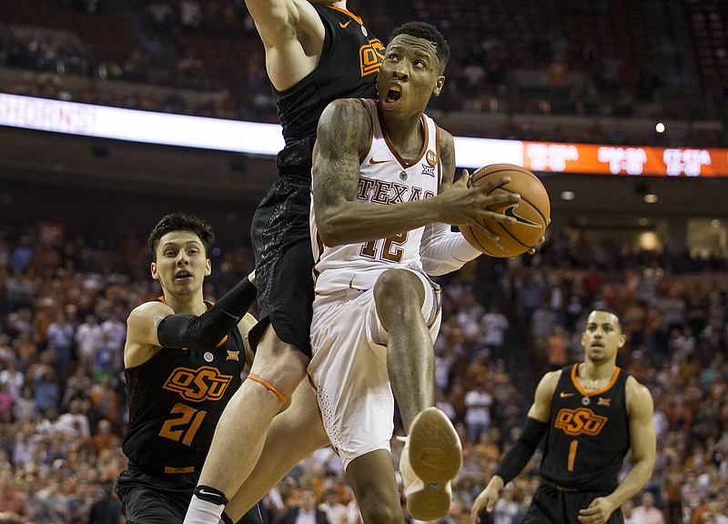 Texas guard Kerwin Roach II (12) eyes the basket before making the game-winning shot in the final seconds of an NCAA college basketball game against Oklahoma State in Austin, Texas, on Saturday, Feb. 24, 2018. (Nick Wagner /Austin American-Statesman via AP)