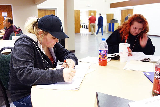 Haylee Skinner, left, and Rachel Waltrip dig into their textbooks during the Tuesday evening High School Equivalency Test class at the John C. Harris Community Center. Waltrip hopes passing the HiSET will bring her one step closer to a career as a registered nurse.