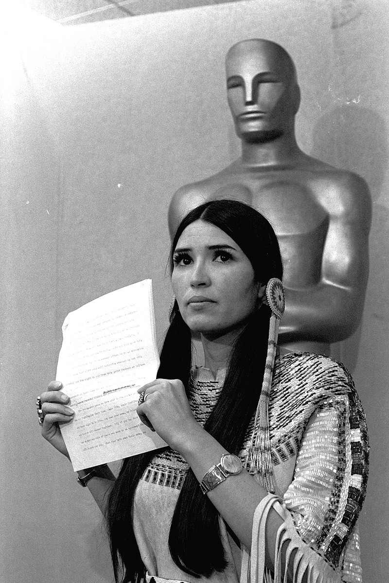 In this March 27, 1973 file photo, Sacheen Littlefeather, tells the audience at the Academy Awards ceremony that Marlon Brando was declining to accept his Oscar as best actor for his role in "The Godfather." The move was meant to protest Hollywood's treatment of American Indians. (AP Photo, File)
