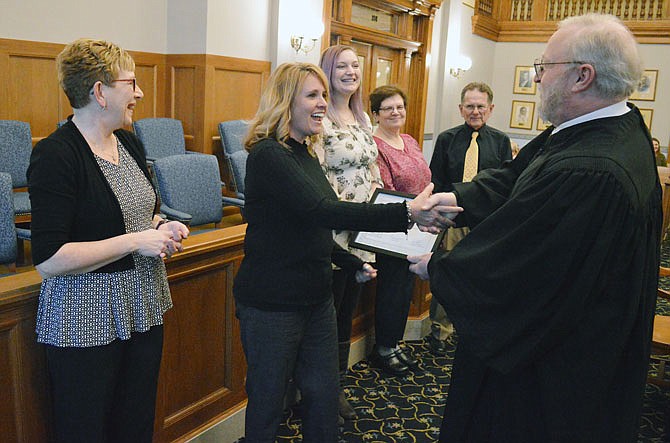 Susan McCurren is congratulated by Judge Jon Beetem on Thursday during a swearing in ceremony for new Court Appointed Special Advocates at the Cole County Courthouse. The new CASA volunteers are, from left: Sharon Goldin, McCurren, Gretchen Ihms, Elizabeth Beach and Peter Boyer.