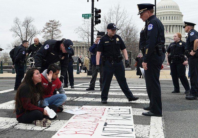 Protesters are arrested as they block the streets near the Capitol and the Supreme Court in Washington, Thursday, March 1, 2018. It's taken just two weeks for Washington's battle over helping young immigrants to fade from blistering to back-burner. Congress now seems likely to do little or nothing this election year on an effort that's been eclipsed by Congress' new focus on guns, bloodied by Senate defeats and relegated to B-level urgency by a Supreme Court ruling.  (AP Photo/Susan Walsh)