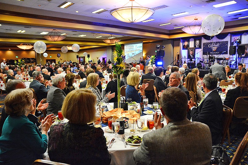 Several attendees clap in response to an introduction speech given Saturday during the Celebrate the Legacy Gala at Capitol Plaza Hotel. The event was held to celebrate those who have made a positive impact on Helias High School.