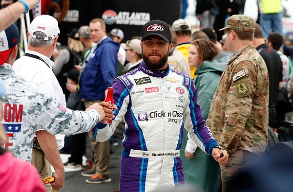NASCAR Cup Series driver Darrell Wallace Jr. (43) greets fans after being introduced last Sunday at Atlanta Motor Speedway in Hampton, Ga.