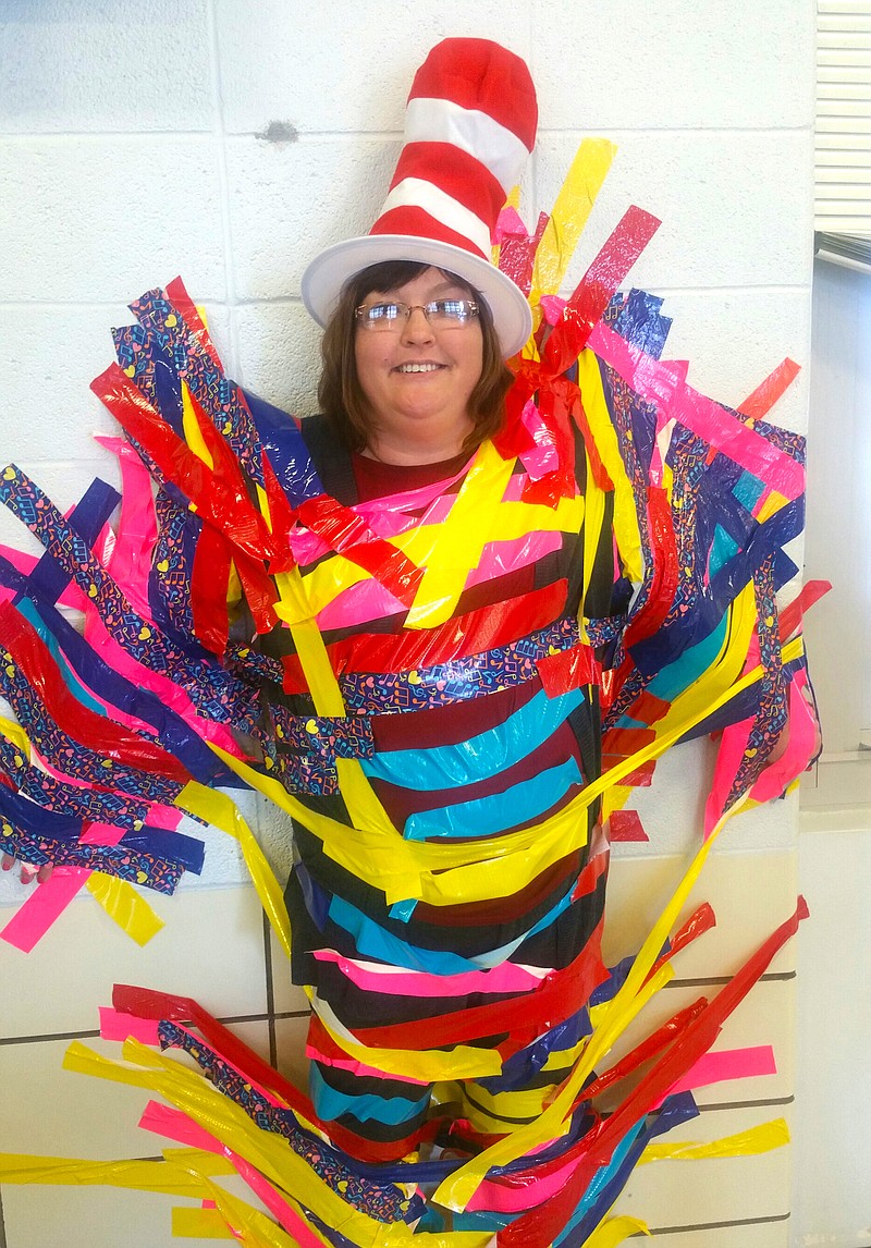 Students at Williamsburg Elementary who achieved the goal of reading 100 minutes per week were invited to help tape principal Tammy Thompson to the wall. (Submitted photo)