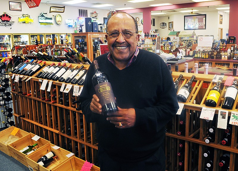 Abiy Hailu, founder of Abiy's International Wines in Jefferson City, holds a bottle of Joseph Phelps Insignia 2014, a $255 red wine from Napa Valley, California. Hailu recently sold his store after 30 years in business. 