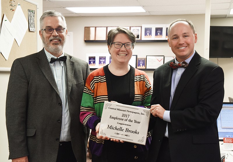 Michelle Brooks was named Central Missouri Newspapers' Employee of the Year for 2017. She is pictured here with Managing Editor Gary Castor, left, and General Manager Zach Ahrens, right.