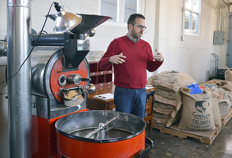 Tony Anderson, owner of Three Story Coffee, explains how his coffee roaster works Thursday at his new roastery at 621 W. McCarty St.
