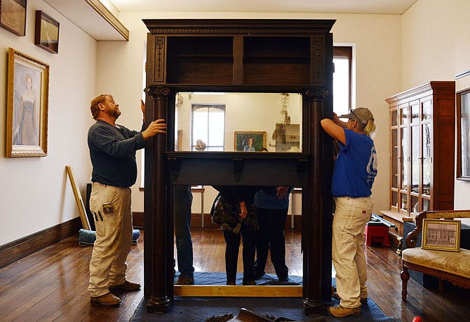 A historic fireplace from the original Governor's Mansion is fitted into place Monday at its new home, the Cole County Historical Society Museum. Doing the heavy lifting were members of Carpenters Local 945 including Dale Verslues, left, and Cindy Frank.