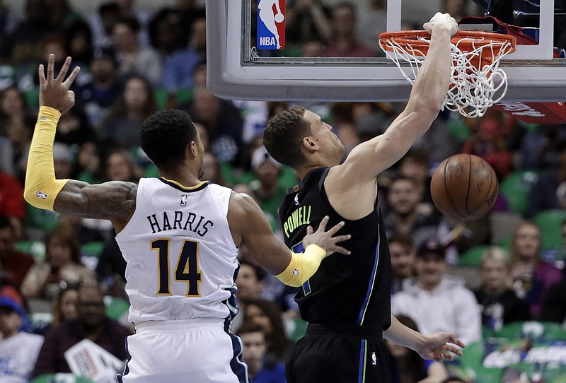 Dallas Mavericks center Dwight Powell (7) dunks after getting past Denver Nuggets guard Gary Harris (14) in the first half of an NBA basketball game in Dallas, Tuesday, March 6, 2018. (AP Photo/Tony Gutierrez)