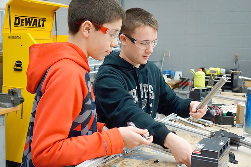 Jacob Moak and Nathan Lowry create the arms for Competition Claw'd in January. Both are freshmen members of Fulton High School's Robotics team. The team has created a robot for a competition this week hosted by Saint Louis University.