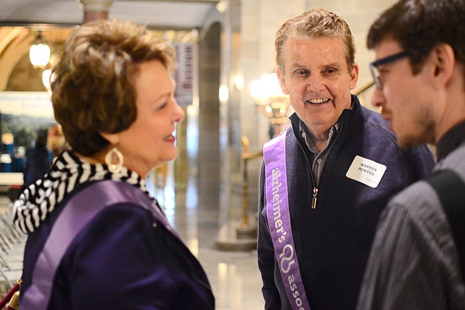 Linda and Warren Powers, center, speak with Matthew Wynn after a rally Wednesday at the Capitol encouraging lawmakers to support grants for those affected by Alzheimer's disease. Warren was diagnosed in 2012, and Wynn is a volunteer for the Alzheimer's Association. 
