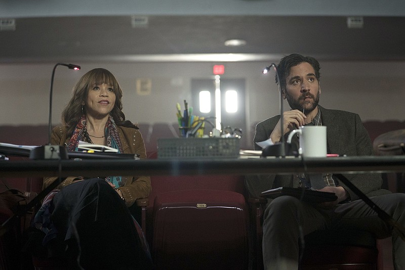 This image released by NBC shows Rosie Perez as Tracey Wolfe, left, and Josh Radnor as Lou Mazzuchelli in a scene from "Rise," debuting Tuesday at 10 p.m. EST. (Peter Kramer/NBC via AP)