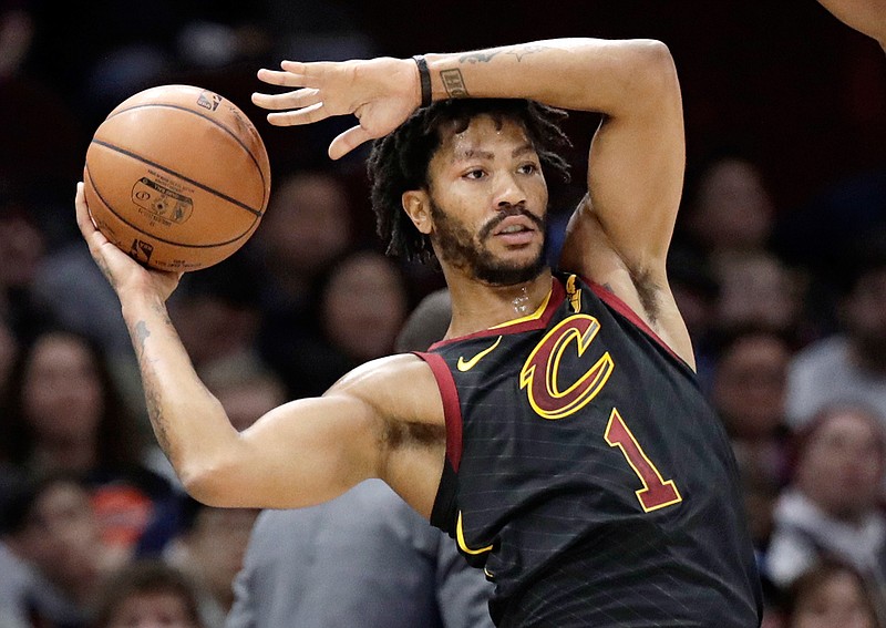 FILE - Int this Jan. 20, 2018, file photo, Cleveland Cavaliers' Derrick Rose (1) passes during the second half of an NBA basketball game against the against the Oklahoma City Thunder in Cleveland. A person familiar with the situation said Thursday, March 8, 2018, that Rose has agreed to sign with the Minnesota Timberwolves for the remainder of the season. Cleveland traded Rose to Utah, and the Jazz waived him before he played there. (AP Photo/Tony Dejak, File)